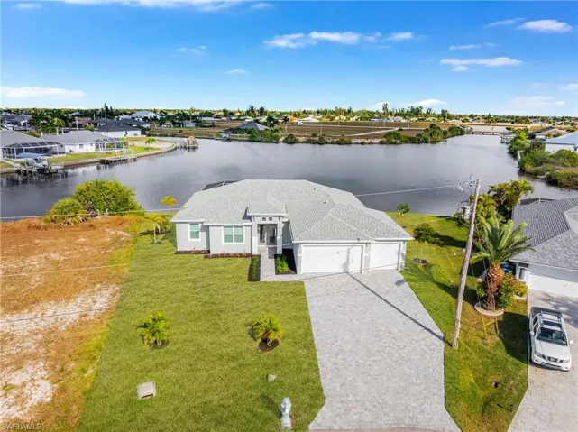 Aerial perspective of suburban area featuring a nearby body of water