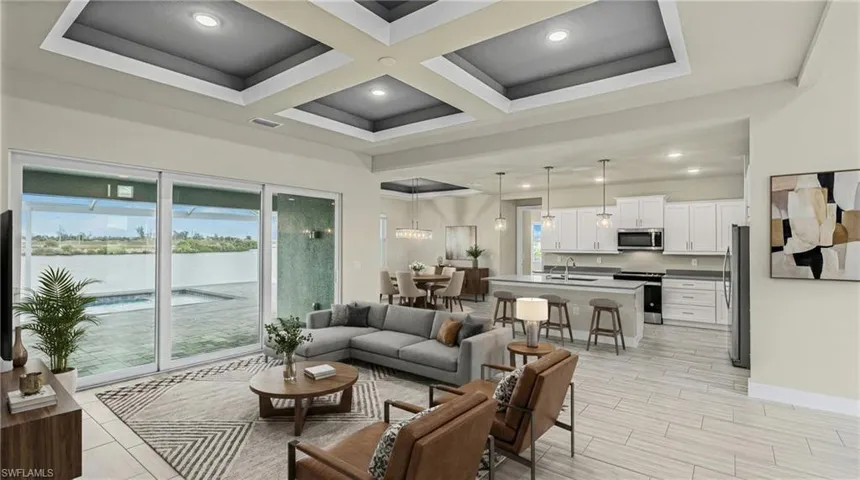 Living area with a water view, coffered ceiling, recessed lighting, wood tiled floors, and beam ceiling