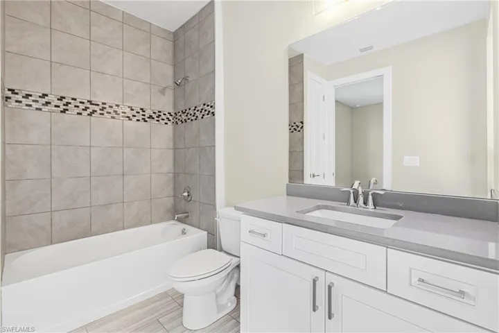 Full bathroom with shower / bath combination and vanity