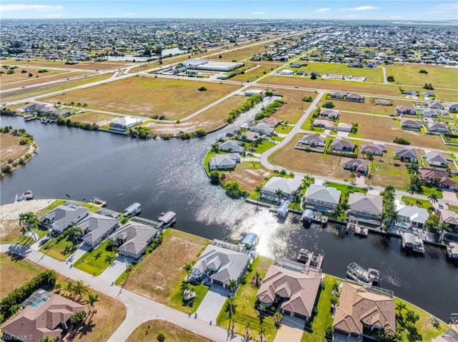 Aerial view of property's location with nearby suburban area and a large body of water
