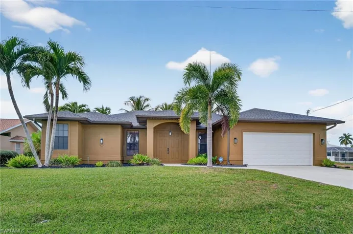 Front with lush landscaping and beds