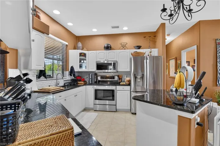 Kitchen with farmers' sink, stainless steel appliances, center island
