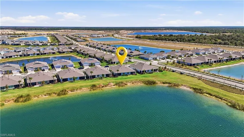 Aerial view of residential area featuring a large body of water
