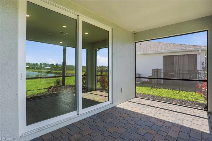 Unfurnished sunroom with a water view and a patio area