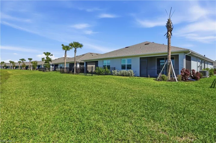 Rear view of property with stucco siding and roof with shingles