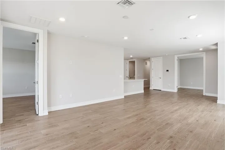 Unfurnished living room featuring light wood-style floors and recessed lighting