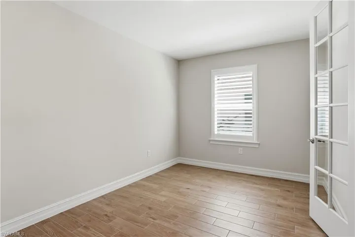 Spare room featuring wood finish floors and baseboards