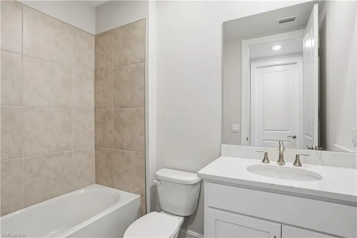 Full bathroom featuring vanity and washtub / shower combination