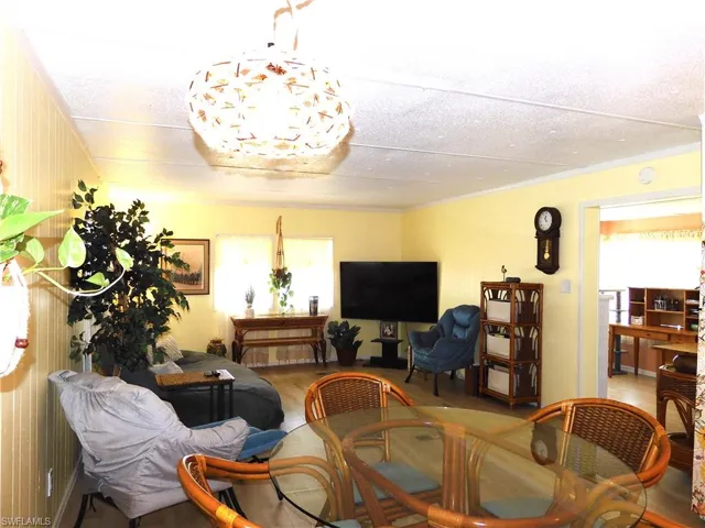 Dining room with tile floors, ornamental molding, and a textured ceiling