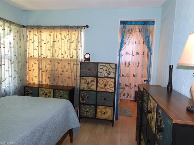 Bedroom with wood-type flooring