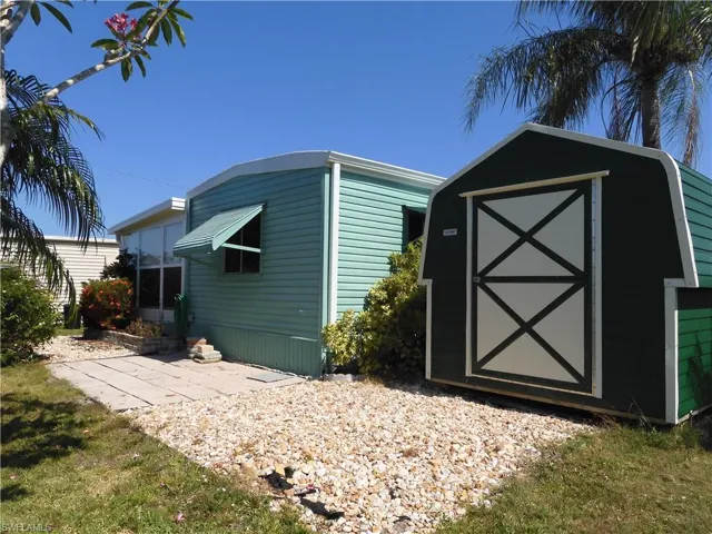 View of property exterior featuring a storage shed