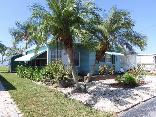 View of property exterior with a lawn