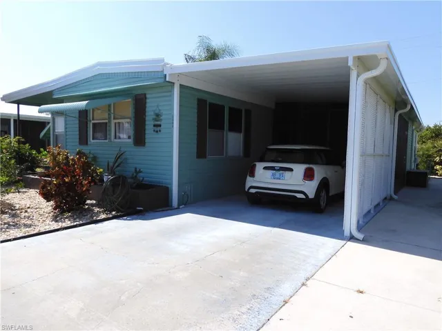 View of front of house with a carport