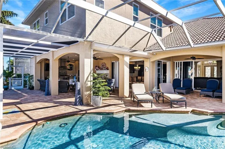 Pool featuring a ceiling fan, a patio area, and an outdoor hangout area