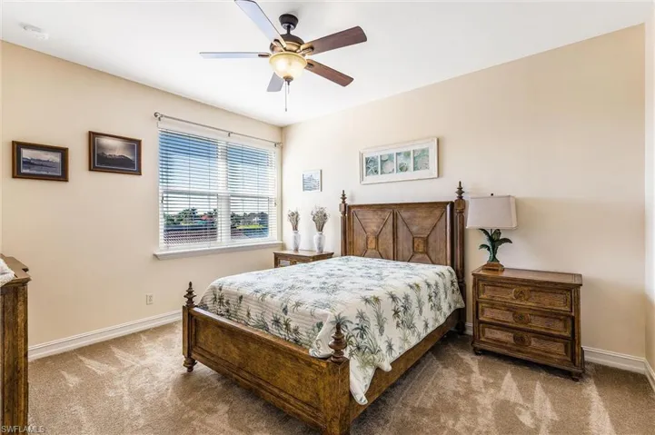 Bedroom with carpet floors, ceiling fan, and baseboards
