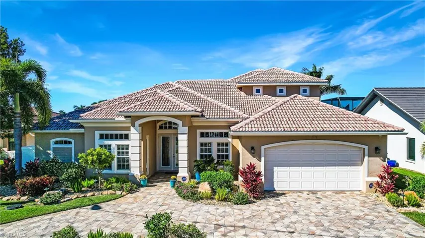 Mediterranean / spanish home featuring a garage, a tile roof, and stucco siding