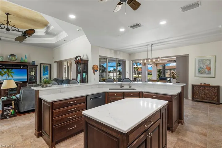 Kitchen featuring open floor plan, a spacious island, a sink, and visible vents