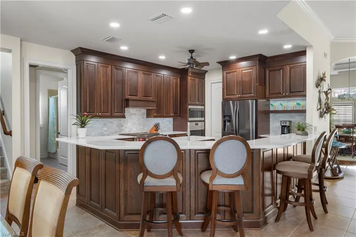 Kitchen featuring a peninsula, visible vents, appliances with stainless steel finishes, and a ceiling fan