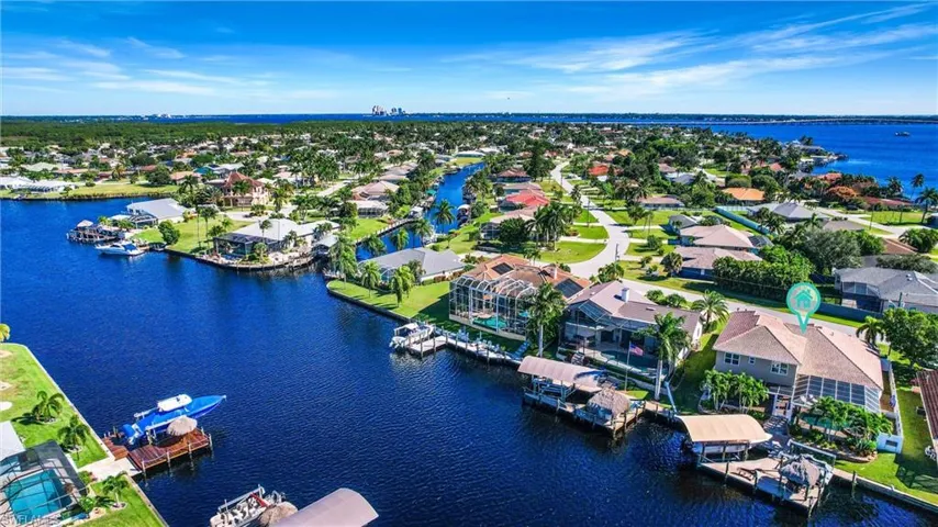 Birds eye view of property with a water view and a residential view