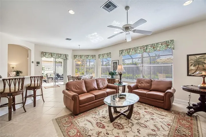 Living room featuring light tile patterned floors, plenty of natural light, recessed lighting, and a ceiling fan