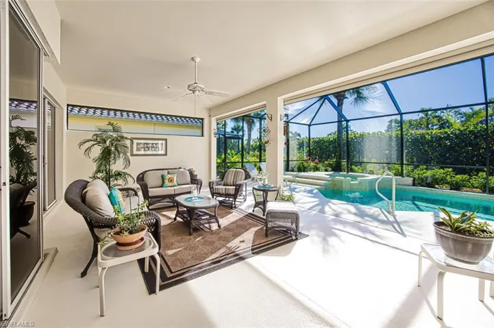 Sunroom with a patio area, ceiling fan, a jacuzzi, and outdoor lounge area