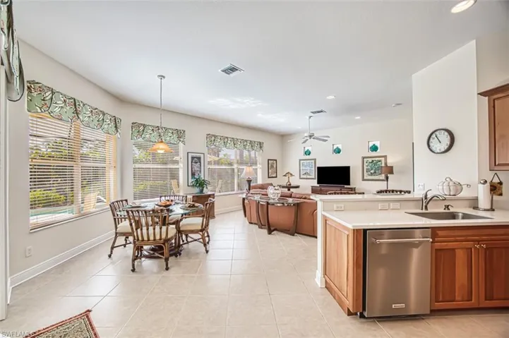 Kitchen featuring stainless steel dishwasher, light tile patterned flooring, recessed lighting, a peninsula, and a ceiling fan