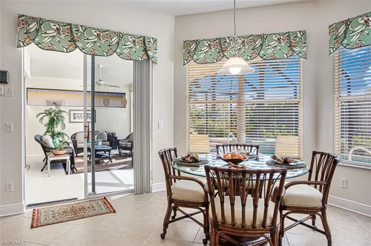 Dining space featuring plenty of natural light and light tile patterned floors