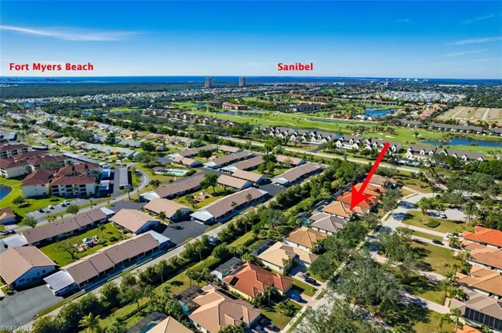 Aerial view of property and surrounding area with a large body of water and nearby suburban area