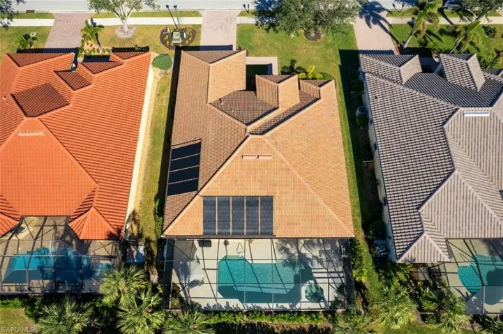 Aerial view of property and surrounding area featuring a pool