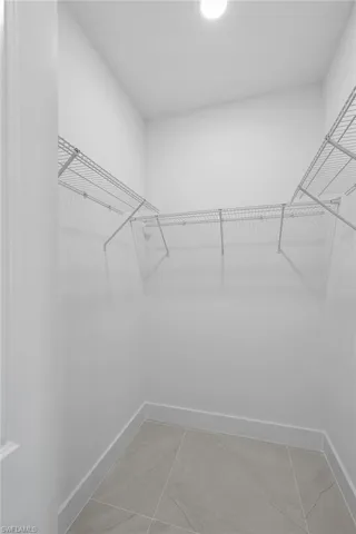 Walk in closet featuring tile patterned floors