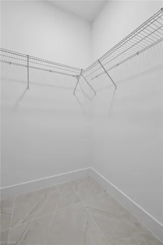 Walk in closet with tile patterned flooring