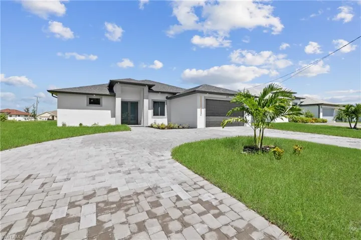 Prairie-style home featuring a garage and a front lawn