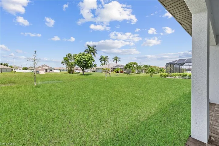 View of yard featuring glass enclosure