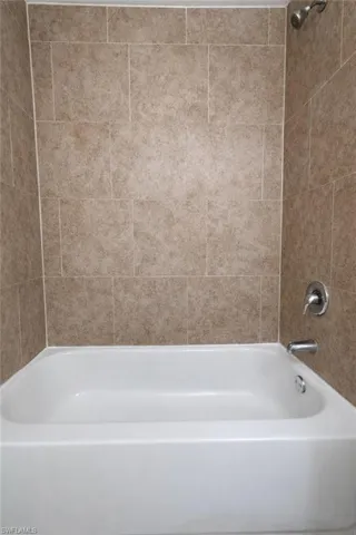 Full bath featuring shower / bath combination