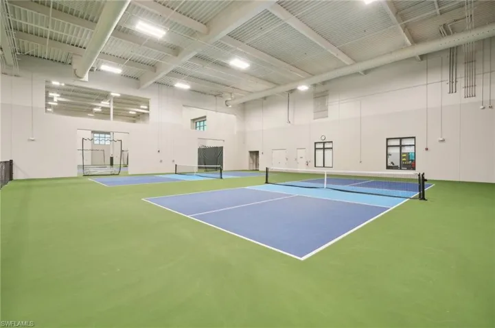 View of tennis court with community basketball court