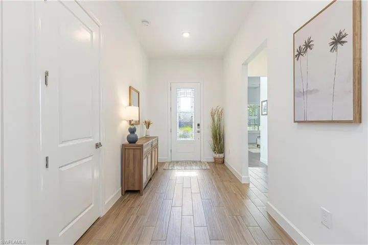 Entryway with baseboards and light wood finished floors