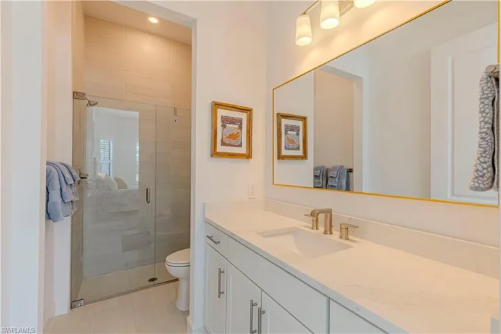 Bathroom with vanity, a stall shower, tile patterned floors, recessed lighting, and toilet