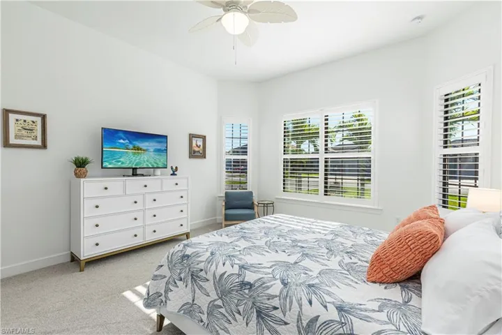 Bedroom with baseboards, carpet flooring, and ceiling fan