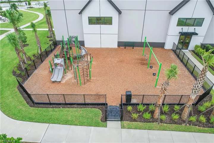 Community playground featuring a yard and fence