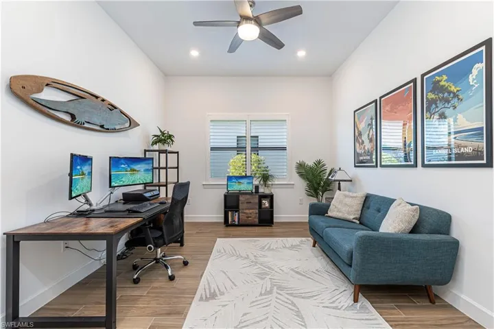 Office area featuring recessed lighting, baseboards, a ceiling fan, and wood finished floors