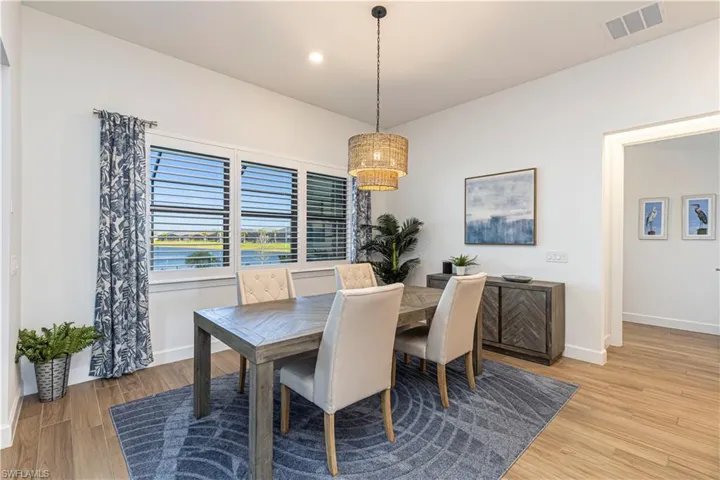Dining space featuring baseboards, an inviting chandelier, recessed lighting, visible vents, and light wood finished floors