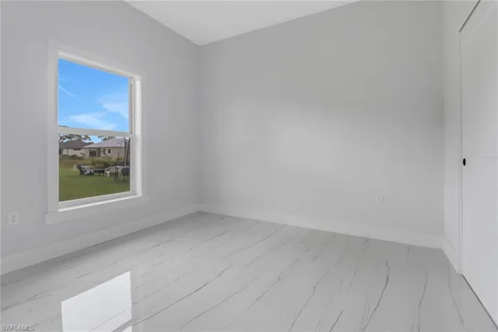 Empty room with light hardwood / wood-style flooring