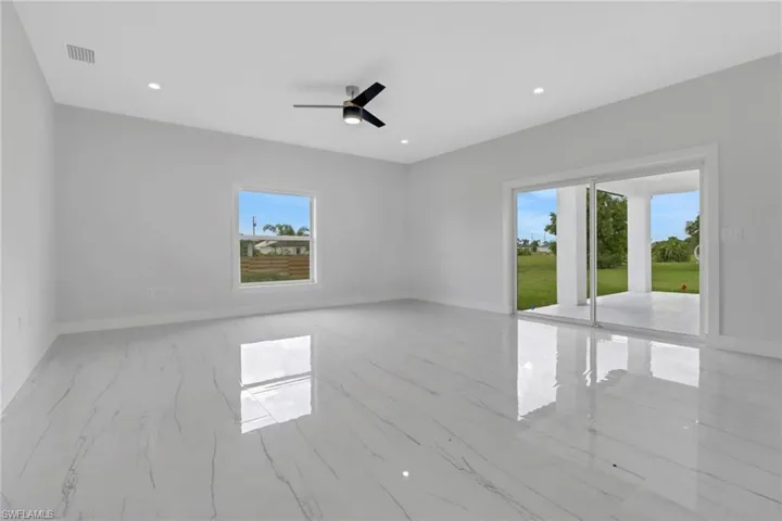Spare room with light tile patterned floors and ceiling fan