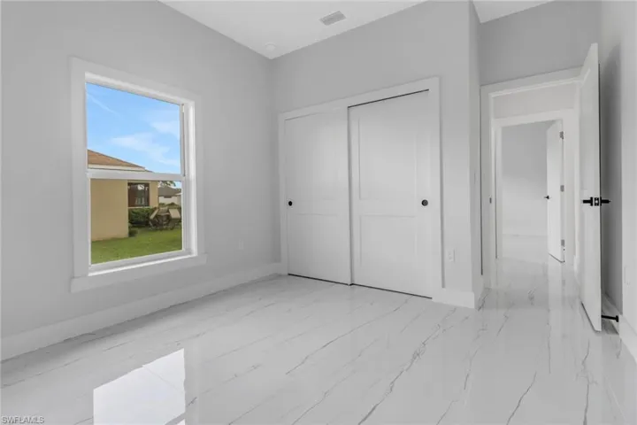 Unfurnished bedroom featuring a closet and light tile patterned flooring