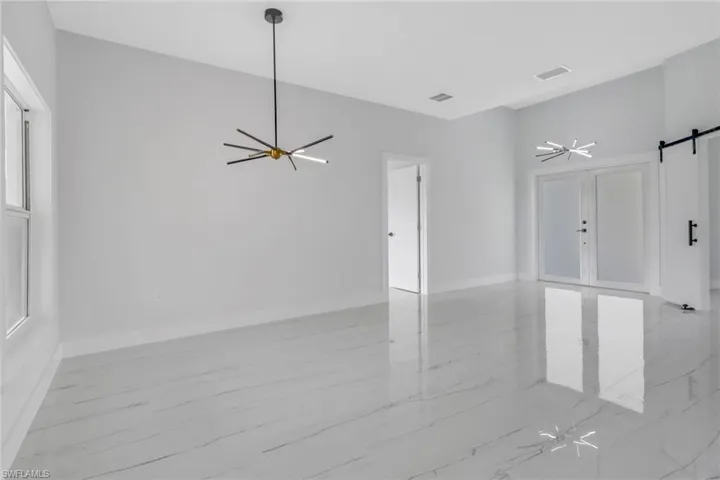 Tiled empty room with a barn door