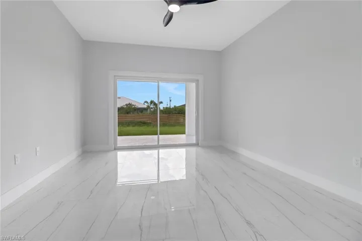 Empty room with light hardwood / wood-style flooring and ceiling fan