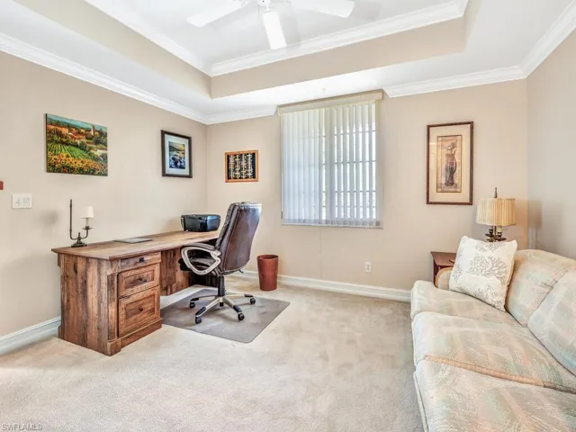 Carpeted office or 3rd bedroom with crown molding, ceiling fan, and a raised ceiling