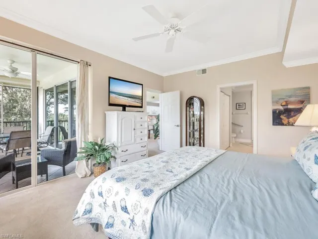 Bedroom with connected bathroom, access to outside, carpet, ceiling fan, and crown molding