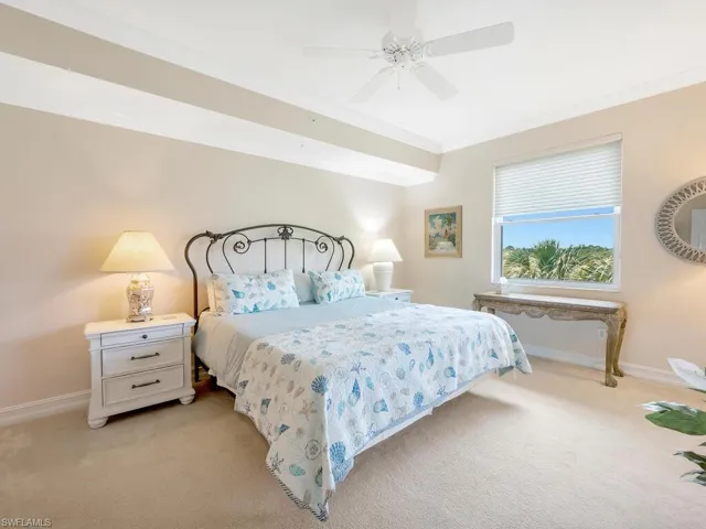 Guest bedroom featuring crown molding, carpet, and ceiling fan
