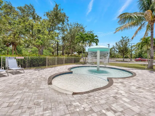 View of swimming pool with a patio area and pool water feature